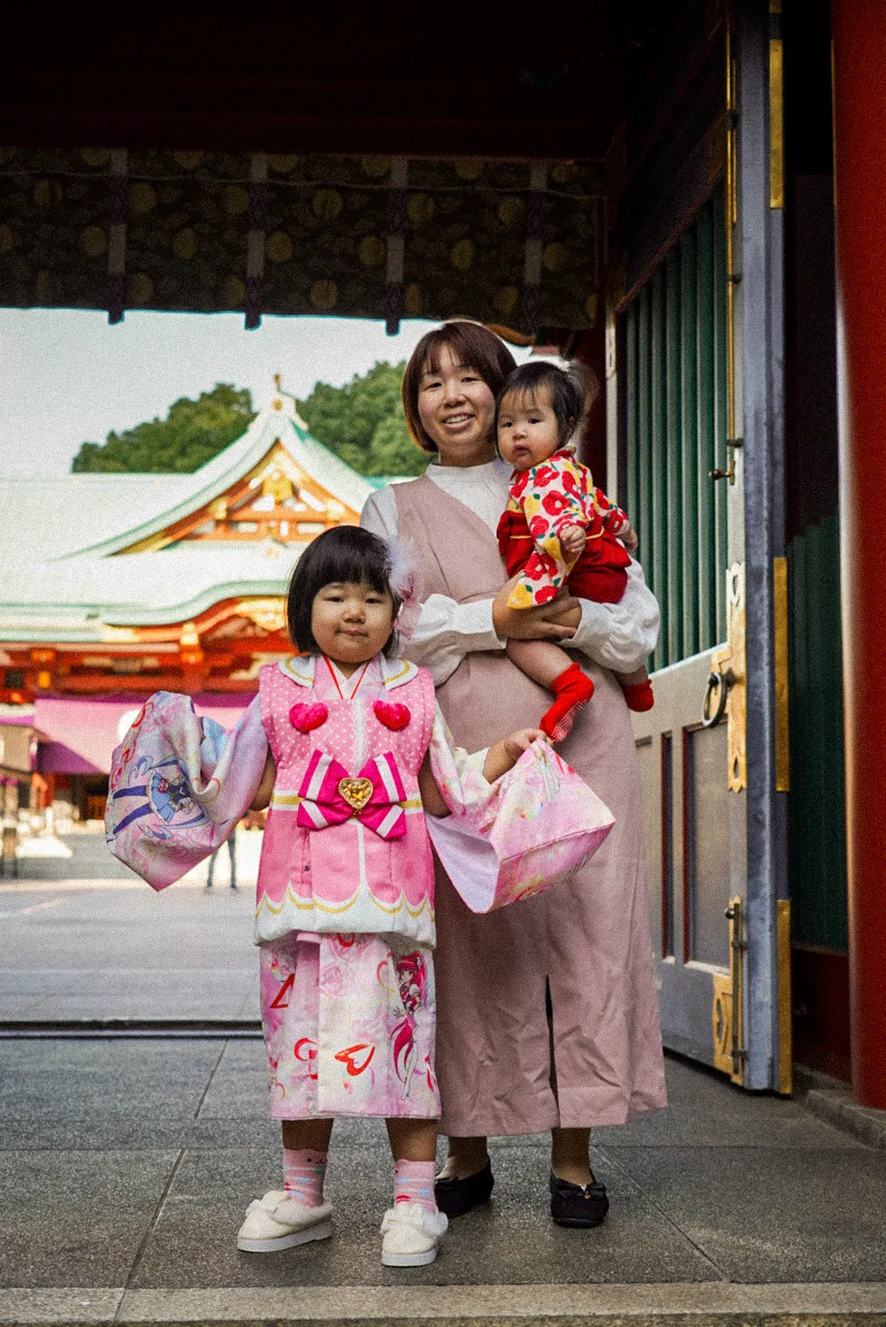 Familia japonesa celebrando un ritual japonés antes de entrar al templo